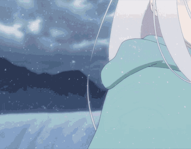 a close up of a person 's shoulder with snow falling in the background