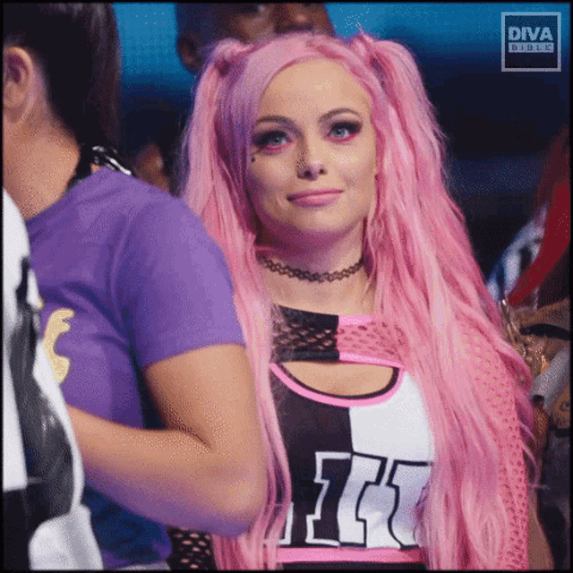 a woman with pink hair is wearing a purple shirt and a choker .