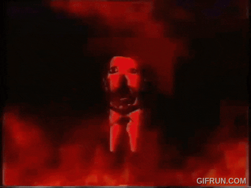 a gif from gifrun.com shows a painting of a man 's face surrounded by fire