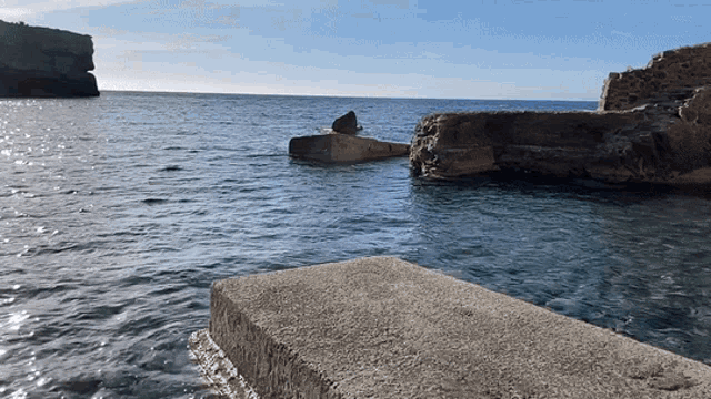 a large rock in the middle of the ocean