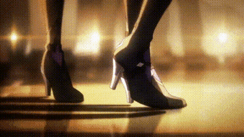 a woman wearing high heels is walking on a stage .
