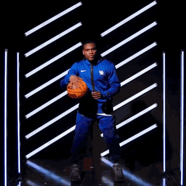 a man wearing a blue jacket with kentucky written on it