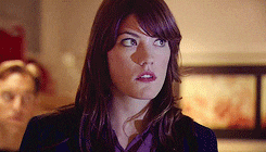 a close up of a woman 's face with a serious look on her face .