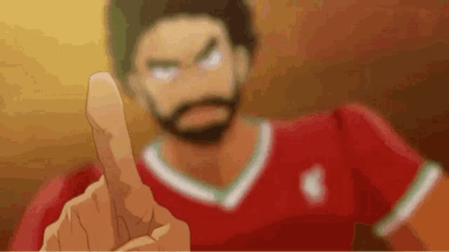 a man with a beard is pointing at the camera with his finger .