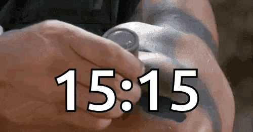 a person is holding a coin in their hand and the time is 15:15 .