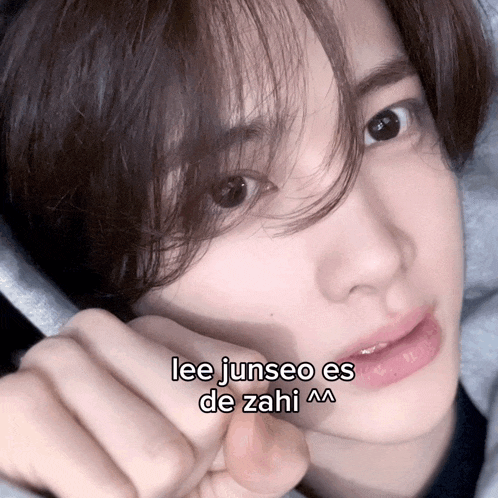 a close up of a person 's face with the words lee junseo es de zahi on it