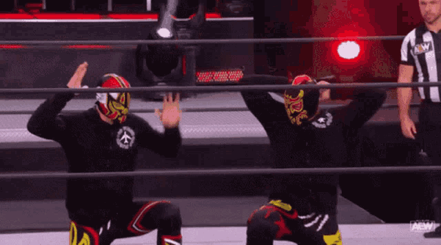 two wrestlers in a ring with the word aew on the bottom right