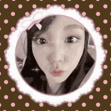 a woman 's face is in a circle with polka dots around it