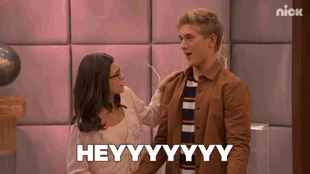 a man and a woman are standing next to each other with the words heyyyyyy written on the bottom