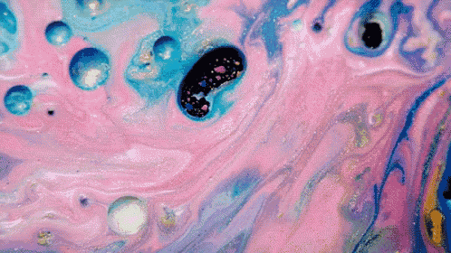 a close up of a pink and blue painting with bubbles in it