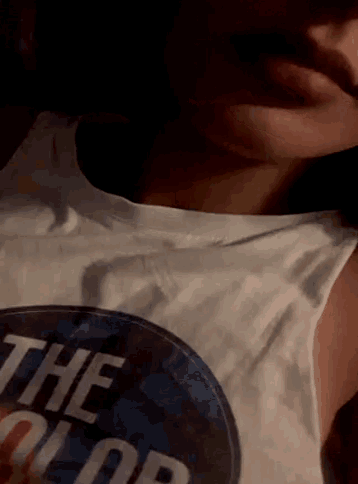 a close up of a person wearing a shirt that says " the color "
