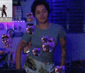 a woman in a blue shirt is standing in front of a purple background .