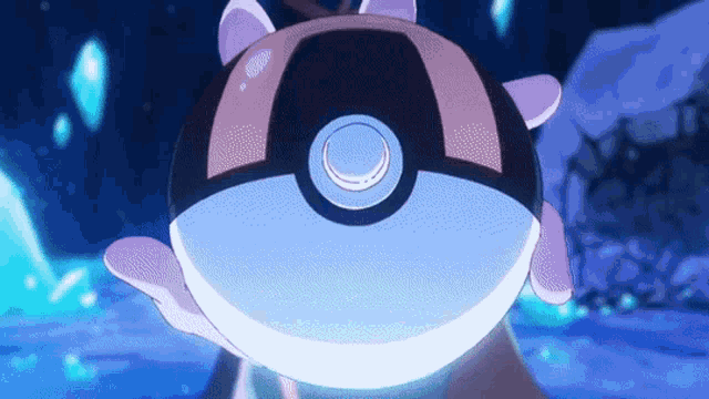 a person is holding a pokemon ball in their hands in a dark room .