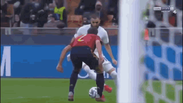 a soccer player wearing a red jersey with the number 2 on it is kicking a soccer ball .