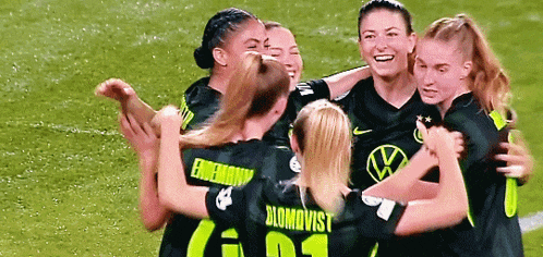a group of female soccer players are hugging each other and one has the number 01 on her jersey