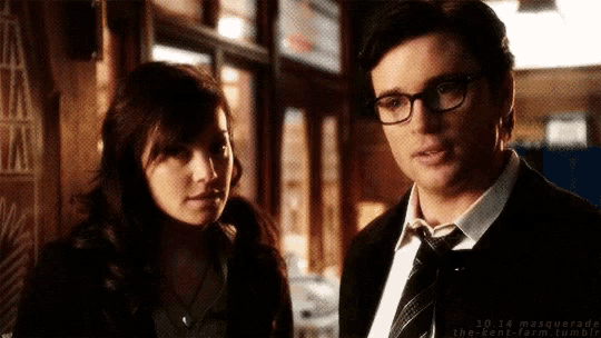 a man and a woman are standing next to each other and looking at each other