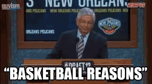a man in a suit and tie stands at a podium with the words " basketball reasons " above him