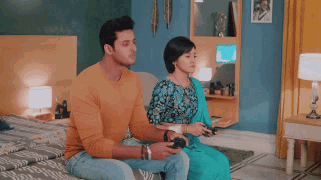 a man and a woman are playing a video game together