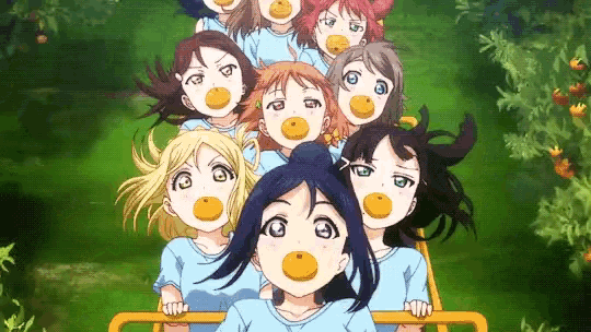 a group of anime girls are riding a roller coaster and eating oranges .