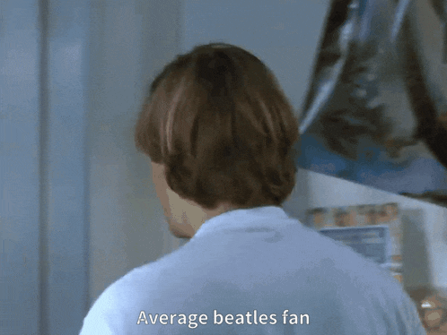 a man in a white shirt is talking about the beatles