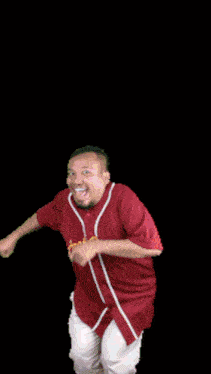 a man in a red shirt is jumping in the air with the words keren banget written above him
