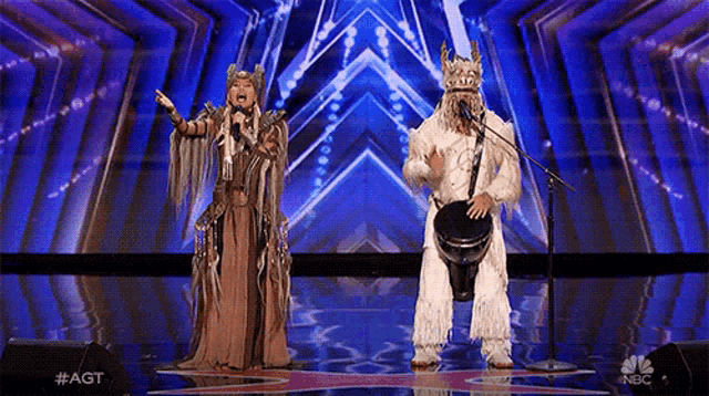 a man is playing a drum and a woman is singing on a stage .