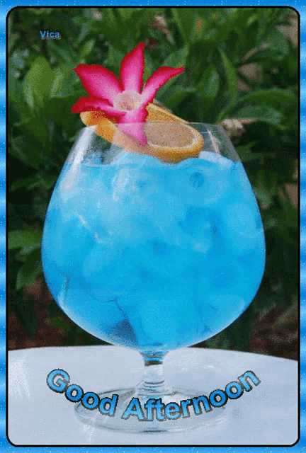 a blue drink in a glass with the words good afternoon written below it