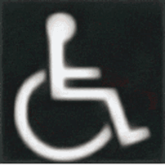a black and white handicap sign with a white outline of a person in a wheelchair