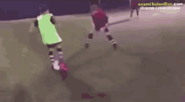 a group of people are playing soccer on a field with a website called cezmikoloniper.com at the bottom