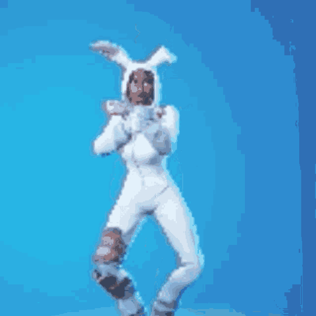 a woman is wearing a white bunny costume and standing on a blue background .