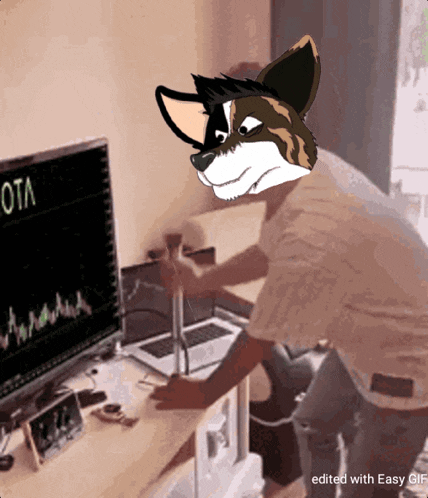 a cartoon of a man with a furry head sitting in front of a computer monitor with ota on it