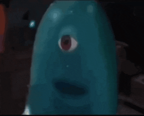a close up of a cartoon character with a red eye .