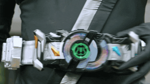 a person is wearing a belt that has a green circle with the letter m on it