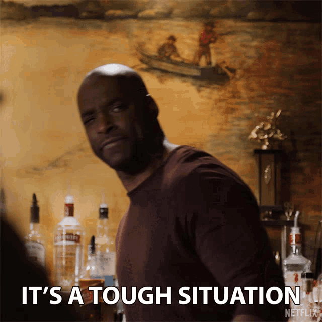 a man says it 's a tough situation in front of bottles of liquor