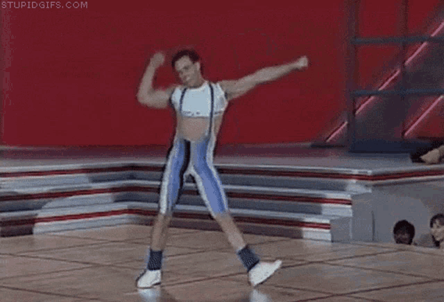a man is dancing on a stage and the website stupidgifs.com is visible