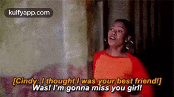 a woman in a red shirt is talking to another woman in a room .