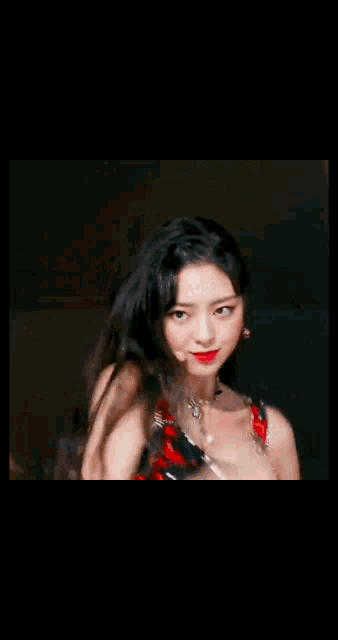 a close up of a woman wearing a red dress and black gloves