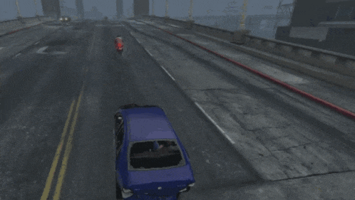 a blue car is driving down a road in the rain