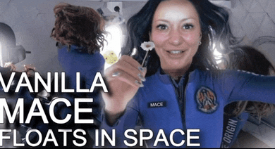 a woman in a space suit holding a flower with the words vanilla mace floats in space
