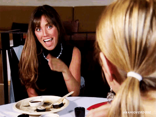 a woman is sitting at a table with a plate of food and the words anahioverdose above her