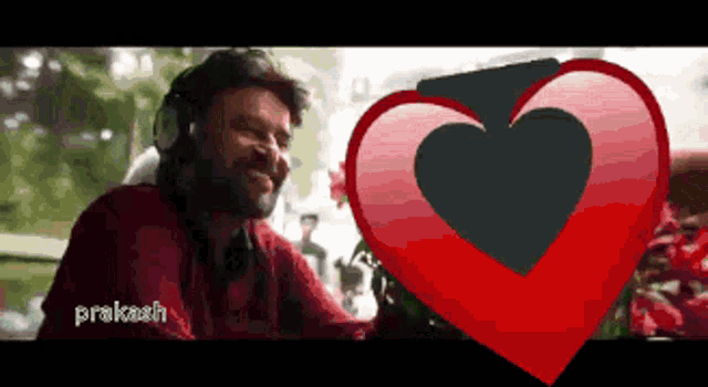 a man wearing headphones is smiling next to a heart with the name prakash on it