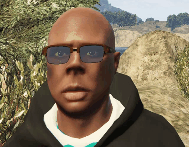 a bald man wearing sunglasses and a hoodie