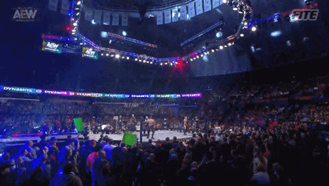 a crowd of people watching a wrestling match with a sign that says corvette blocked me !!
