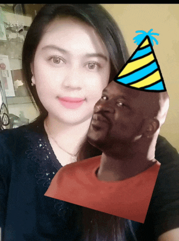 a woman with a party hat on her head stands next to a bald man