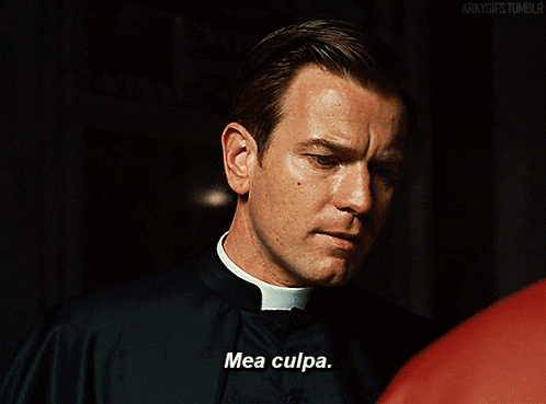 a priest says mea culpa in front of a red shirt