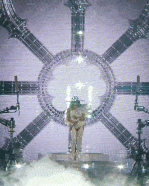 a woman is standing in front of a circle of lights
