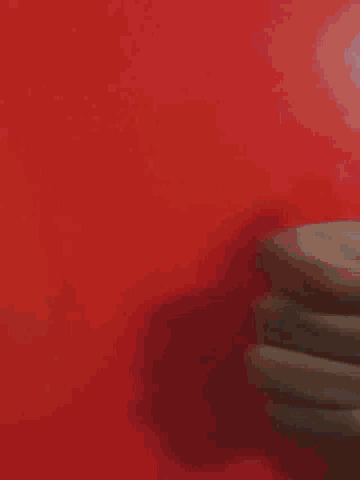 a close up of a person 's hand giving a thumbs down