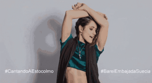 a woman in a crop top is dancing in front of a banner that says bccdf