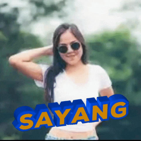 a woman wearing sunglasses and a white shirt has the word sayang in blue and yellow