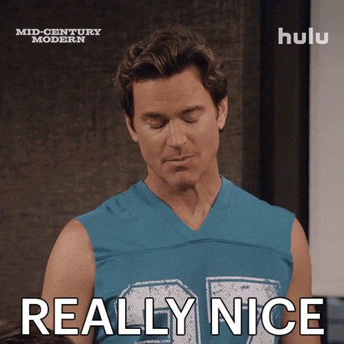 a man in a blue shirt says really nice in front of a hulu logo